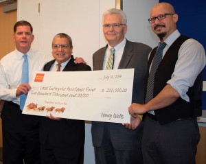 Boston Mayor Martin Walsh (left) with representatives from the Local Enterprise Assistance Fund accepting a donation from Wells Fargo.